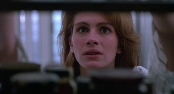 Movie still from “Sleeping with the Enemy” (1991), directed by Joseph Ruben – A person looking at something in a mirror; Close Up shot, Low angle