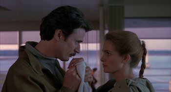 Movie still from “Sleeping with the Enemy” (1991), directed by Joseph Ruben – A man and a woman looking at one another; Close Up shot, Low angle