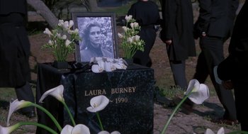 Movie still from “Sleeping with the Enemy” (1991), directed by Joseph Ruben – A grave with flowers and a picture of a woman; Medium shot, High angle
