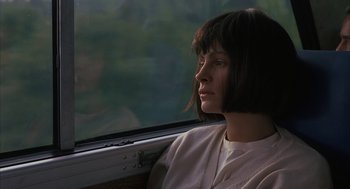 Movie still from “Sleeping with the Enemy” (1991), directed by Joseph Ruben – A woman sitting on a train looking out the window; Close Up shot, Over the shoulder angle