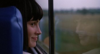 Movie still from “Sleeping with the Enemy” (1991), directed by Joseph Ruben – A woman looking out of a window on a train; Close Up shot, Over the shoulder angle