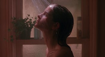 Movie still from “Sleeping with the Enemy” (1991), directed by Joseph Ruben – A woman is taking a shower in a bathroom; Close Up shot, Low angle