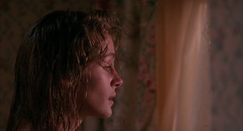 Movie still from “Sleeping with the Enemy” (1991), directed by Joseph Ruben – A person with wet hair; Close Up shot, Low angle