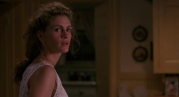 Movie still from “Sleeping with the Enemy” (1991), directed by Joseph Ruben – A beautiful young lady standing in a room; Close Up shot, Over the shoulder angle
