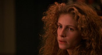 Movie still from “Sleeping with the Enemy” (1991), directed by Joseph Ruben – A person with curly red hair; Close Up shot, Over the shoulder angle