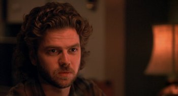 Movie still from “Sleeping with the Enemy” (1991), directed by Joseph Ruben – A person with a beard; Close Up shot, Over the shoulder angle