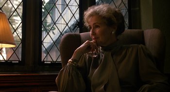 Movie still from “Sleeping with the Enemy” (1991), directed by Joseph Ruben – A woman sitting in a chair with her hand on her chin; Close Up shot, Over the shoulder angle