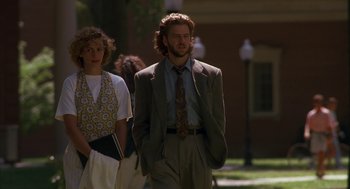 Movie still from “Sleeping with the Enemy” (1991), directed by Joseph Ruben – A man in a suit standing next to a woman in a suit; Medium shot, Low angle