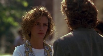 Movie still from “Sleeping with the Enemy” (1991), directed by Joseph Ruben – A woman with curly hair is talking to another woman; Close Up shot, Over the shoulder angle