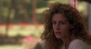 Movie still from “Sleeping with the Enemy” (1991), directed by Joseph Ruben – A person with curly hair; Close Up shot, Over the shoulder angle