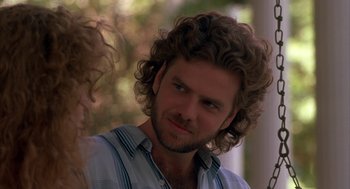 Movie still from “Sleeping with the Enemy” (1991), directed by Joseph Ruben – A person wearing a shirt with curly hair; Close Up shot, Over the shoulder angle