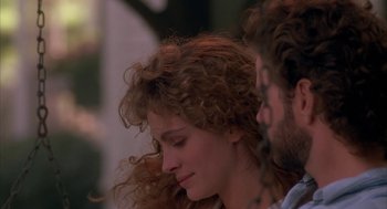 Movie still from “Sleeping with the Enemy” (1991), directed by Joseph Ruben – A person with curly hair; Close Up shot, Over the shoulder angle