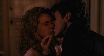 Movie still from “Sleeping with the Enemy” (1991), directed by Joseph Ruben – A man and a woman are kissing in a room; Close Up shot, Low angle