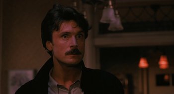 Movie still from “Sleeping with the Enemy” (1991), directed by Joseph Ruben – A person with a mustache; Close Up shot, Low angle