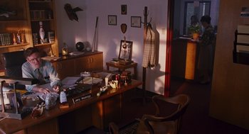 Movie still from “Sling Blade” (1996), directed by Billy Bob Thornton – A room with a lot of furniture in it; Wide shot, High angle