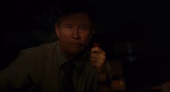 Movie still from “Sling Blade” (1996), directed by Billy Bob Thornton – A man smoking a pipe in a dark room; Close Up shot, High angle