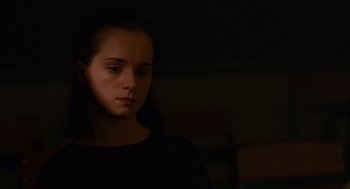 Movie still from “Sling Blade” (1996), directed by Billy Bob Thornton – A young girl in a dark room looking sad; Close Up shot, Low angle