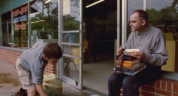 Movie still from “Sling Blade” (1996), directed by Billy Bob Thornton – A man and a boy sitting on a bench; Medium shot, Over the shoulder angle