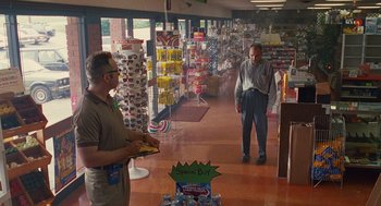 Movie still from “Sling Blade” (1996), directed by Billy Bob Thornton – Two men are in a store looking at a display of sunglasses; Wide shot, Low angle