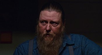 Movie still from “Sling Blade” (1996), directed by Billy Bob Thornton – A person with a long beard; Close Up shot, Over the shoulder angle