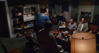 Movie still from “Sling Blade” (1996), directed by Billy Bob Thornton – A group of people sitting around a living room; Wide shot, High angle