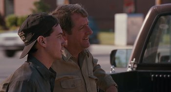 Movie still from “Sling Blade” (1996), directed by Billy Bob Thornton – A man and a young boy sitting next to each other; Medium shot, Over the shoulder angle