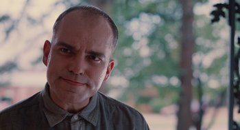 Movie still from “Sling Blade” (1996), directed by Billy Bob Thornton – A person wearing a gray shirt; Close Up shot, Low angle
