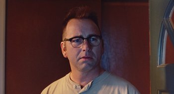 Movie still from “Sling Blade” (1996), directed by Billy Bob Thornton – A person wearing glasses; Close Up shot, Low angle