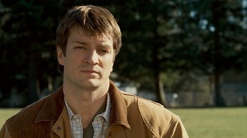 Movie still from “Slither” (2006), directed by James Gunn – A person wearing a jacket; Close Up shot, Over the shoulder angle