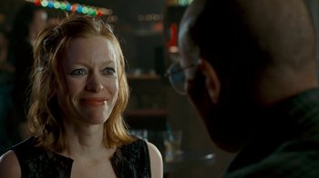 Movie still from “Slither” (2006), directed by James Gunn – A woman smiles at a man in a bar; Close Up shot, Over the shoulder angle