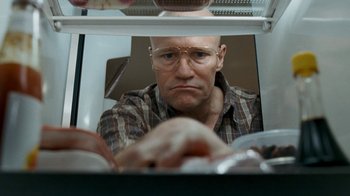 Movie still from “Slither” (2006), directed by James Gunn – A man with glasses looking in a refrigerator; Close Up shot, Low angle