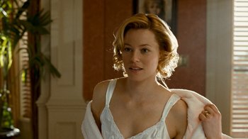 Movie still from “Slither” (2006), directed by James Gunn – A woman in a white dress and a white fur stole; Close Up shot, Over the shoulder angle