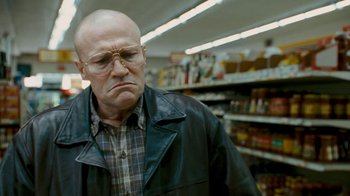 Movie still from “Slither” (2006), directed by James Gunn – An older man with glasses is in a store; Close Up shot, Low angle