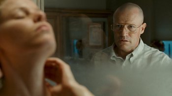 Movie still from “Slither” (2006), directed by James Gunn – A man with glasses looking in the mirror; Close Up shot, Over the shoulder angle