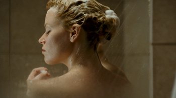 Movie still from “Slither” (2006), directed by James Gunn – A young woman is taking a shower in the bathroom; Close Up shot, Overhead angle