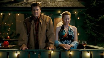 Movie still from “Slither” (2006), directed by James Gunn – A man and a woman standing next to each other; Medium shot, Over the shoulder angle