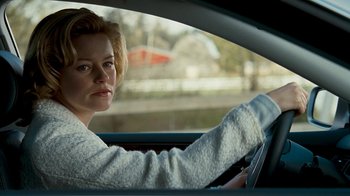 Movie still from “Slither” (2006), directed by James Gunn – A woman sitting in the drivers seat of a car; Close Up shot, Over the shoulder angle