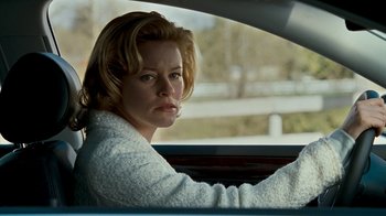 Movie still from “Slither” (2006), directed by James Gunn – A woman sitting in the driver's seat of a car; Close Up shot, Over the shoulder angle