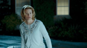 Movie still from “Slither” (2006), directed by James Gunn – A woman with blonde hair wearing a white sweater; Medium shot, Over the shoulder angle