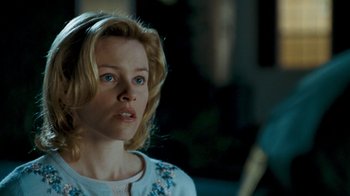 Movie still from “Slither” (2006), directed by James Gunn – A woman with blonde hair and blue eyes looking to her left; Close Up shot, Over the shoulder angle