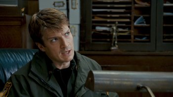 Movie still from “Slither” (2006), directed by James Gunn – A person sitting in a chair; Close Up shot, Over the shoulder angle