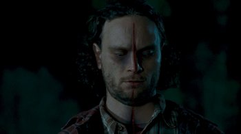 Movie still from “Slither” (2006), directed by James Gunn – A person with blood on their face; Close Up shot, Overhead angle