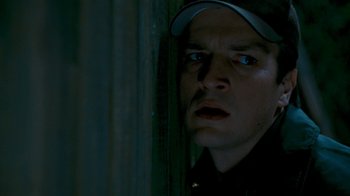 Movie still from “Slither” (2006), directed by James Gunn – A person wearing a hat; Close Up shot, Low angle