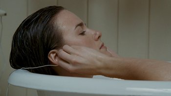 Movie still from “Slither” (2006), directed by James Gunn – A woman in a bath tub getting a massage; Close Up shot, Overhead angle