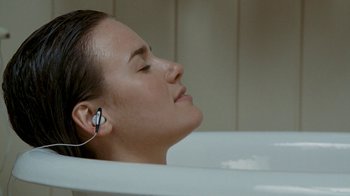 Movie still from “Slither” (2006), directed by James Gunn – A woman with her eyes closed in a bath tub; Close Up shot, Overhead angle