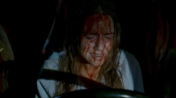 Movie still from “Slither” (2006), directed by James Gunn – A woman with blood all over her face; Close Up shot, High angle