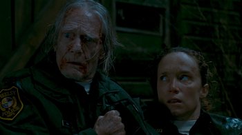 Movie still from “Slither” (2006), directed by James Gunn – An old man and a young girl sitting next to each other; Close Up shot, Low angle