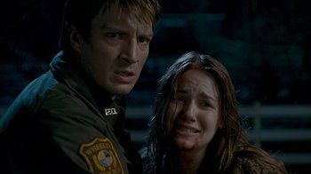Movie still from “Slither” (2006), directed by James Gunn – A man and a woman with blood on their face; Close Up shot, Over the shoulder angle