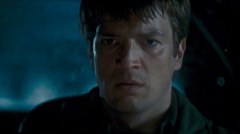 Movie still from “Slither” (2006), directed by James Gunn – A person with short brown hair; Close Up shot, Low angle