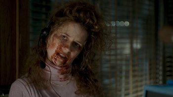 Movie still from “Slither” (2006), directed by James Gunn – A woman with blood all over her face and neck; Close Up shot, Low angle